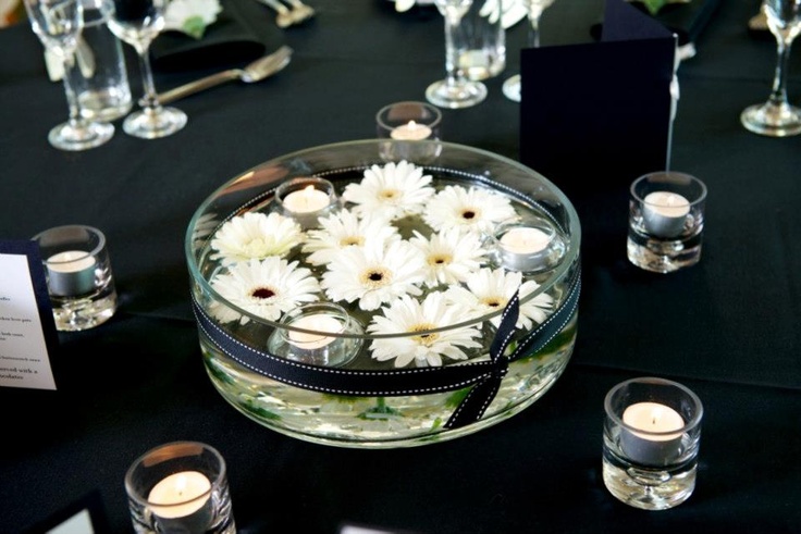 simple, yet elegant, way to use Gerber daisies floating in bowl with floating candles, or not daisy flower candles for candle light dinner